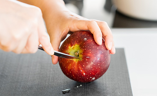 りんごの芯をナイフで取り除いているところ